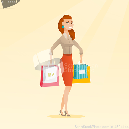 Image of Young happy caucasian woman with shopping bags.