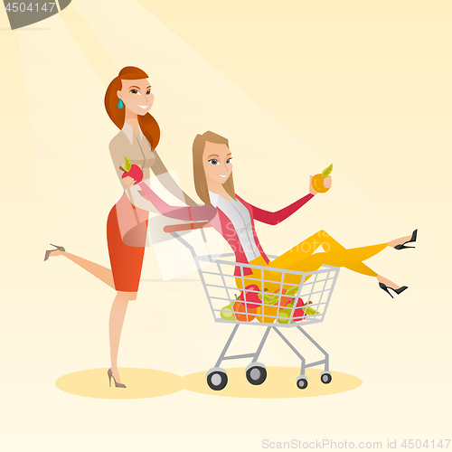 Image of Couple of friends riding in shopping trolley.