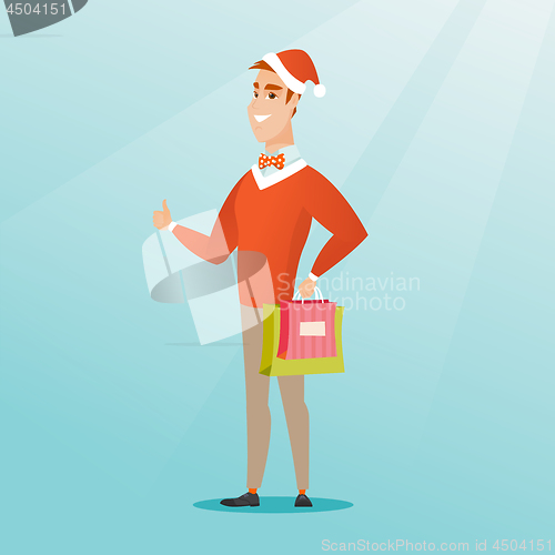 Image of Man in santa hat shopping for christmas gifts.