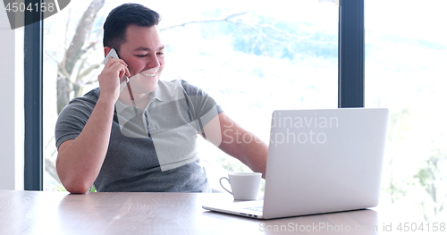 Image of businessman working using a laptop in startup office