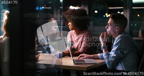 Image of Multiethnic startup business team in night office