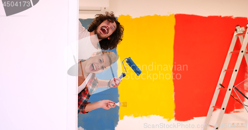 Image of portrait of a couple painting interior wall