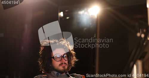 Image of man working on computer in dark office