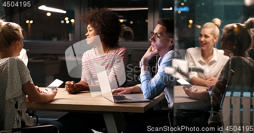 Image of Multiethnic startup business team in night office