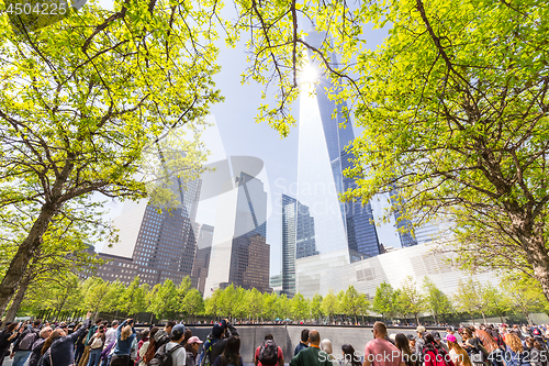 Image of Tourists visiting 9 11 memorial park in downtown Manhattan, located on the site as the original World Trade Center.