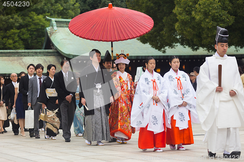 Image of Young happy groom and bride during japanese traditional wedding ceremony at Meiji-jingu shrine in Tokyo, Japan on November 23, 2013.