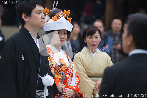 Image of Young happy groom and bride during japanese traditional wedding ceremony at Meiji-jingu shrine in Tokyo, Japan on November 23, 2013.