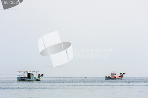 Image of Two small fishing boat at sea surface