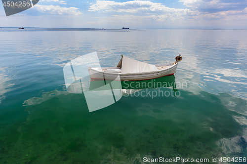 Image of Small fishing boat at sea surface