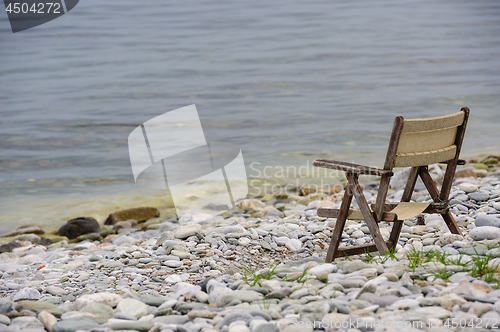 Image of old wooden foldable chair at the beach