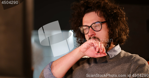 Image of man working on computer in dark office