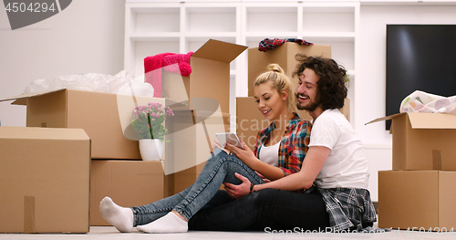 Image of young couple moving  in new house