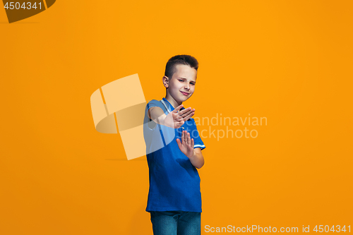 Image of Young serious thoughtful teen boy. Doubt concept.