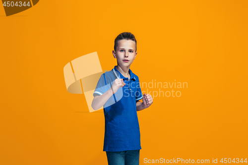 Image of Beautiful teen boyl looking suprised isolated on orange