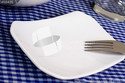 Image of Empty plate on a dining table

