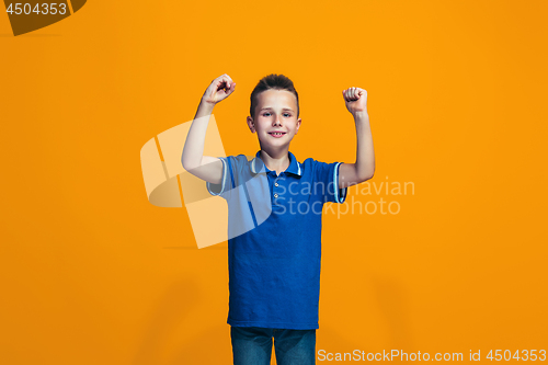 Image of Happy success teen boy celebrating being a winner. Dynamic energetic image of female model