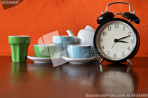 Image of Alarm clock with colorful tea set
