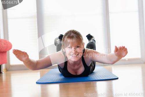 Image of Girl does exercise to strengthen her back