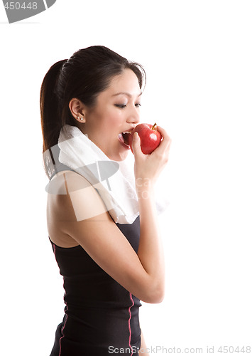 Image of Asian girl exercise and eating apple