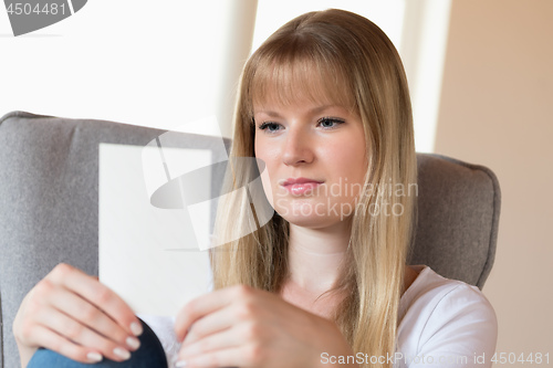 Image of Sad girl holding photo