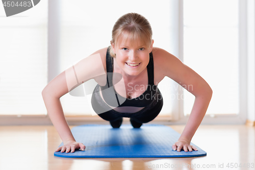 Image of Girl doing pushups exercises