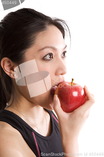 Image of Asian girl eating an apple