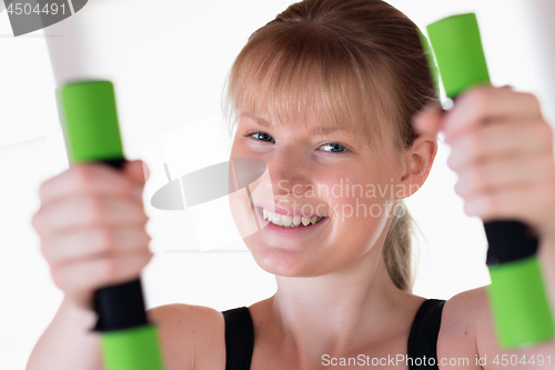 Image of Girl doing dumbbell exercises