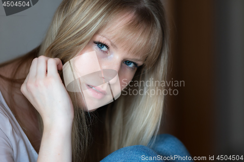 Image of Sad girl is sitting on the floor