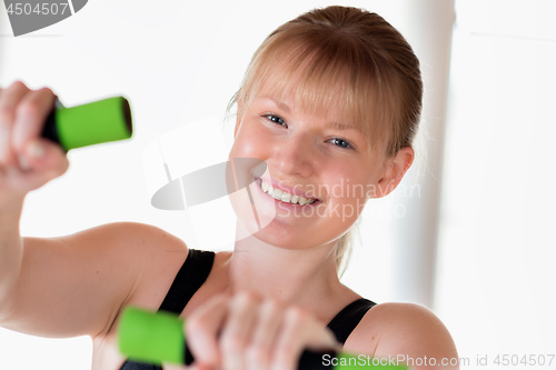 Image of Girl doing dumbbell exercises