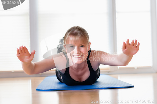 Image of Girl does exercise to strengthen her back