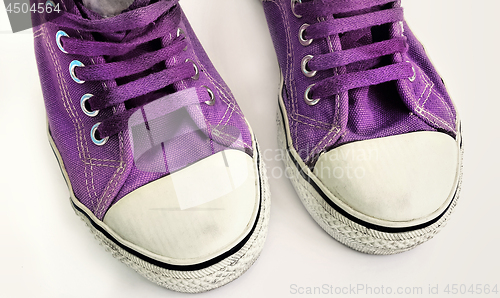 Image of Old lilac sneakers, close-up