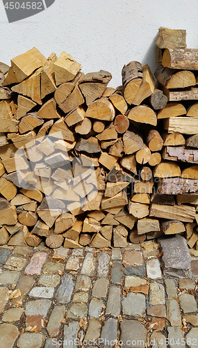Image of Firewood pile stacked chopped wood trunks