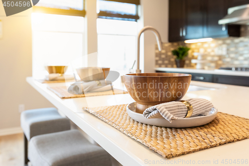 Image of Wooden Bowl Place Settings on Kitchen Island Abstract