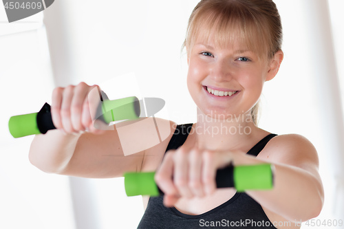 Image of Girl doing dumbbell exercises