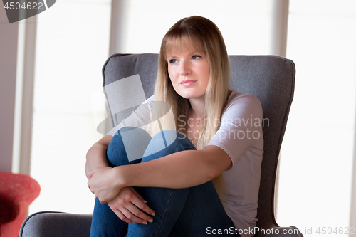 Image of Sad girl sitting on chair