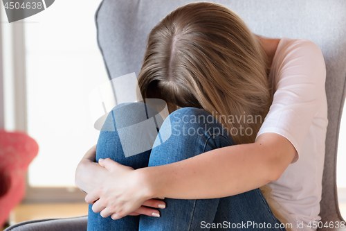 Image of Sad girl sitting on chair