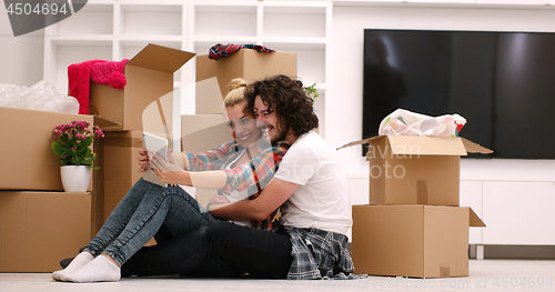 Image of young couple moving  in new house