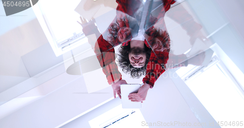 Image of young man using a tablet at home