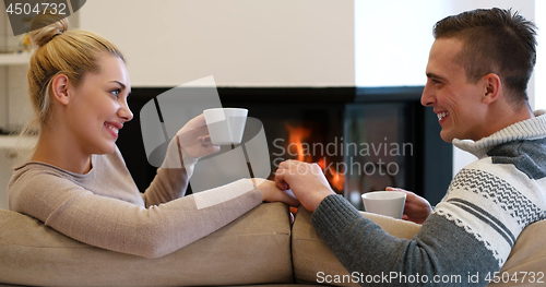 Image of Young couple  in front of fireplace