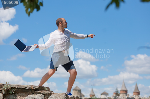 Image of young man throws a laptop