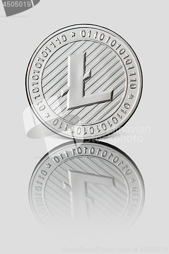 Image of Silver coin Litecoin on white glossy background. Business and technology concept