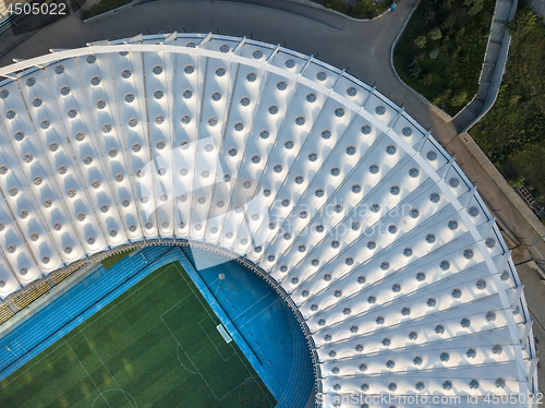 Image of KYIV, UKRAINE - July 19, 2018. NSC Olimpiysky the birds eye view from drone of construction the stadium roof, green football field, tribunes of complex.