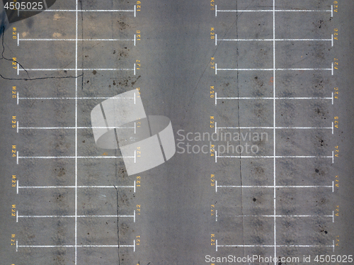 Image of Asphalt floor with parking lot at city center, vacant parking lot. Parking lane painting on floor with numbered places.