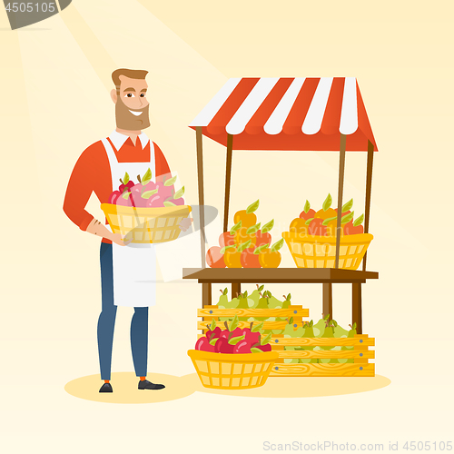 Image of Greengrocer holding box full of apples.