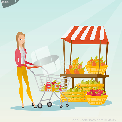 Image of Young caucasian woman pushing a supermarket cart.