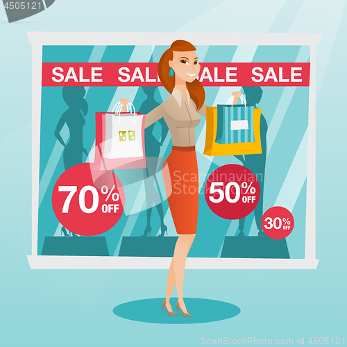 Image of Young caucasian woman shopping on sale.