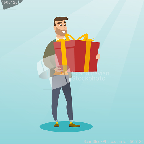 Image of Young caucasian man holding box with gift.