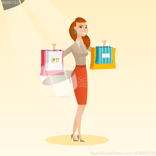 Image of Young caucasian woman holding shopping bags.