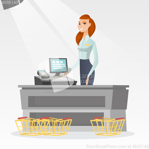 Image of Cashier standing at the checkout in a supermarket.