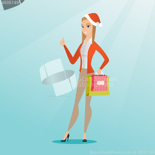 Image of Woman in santa hat shopping for christmas gifts.